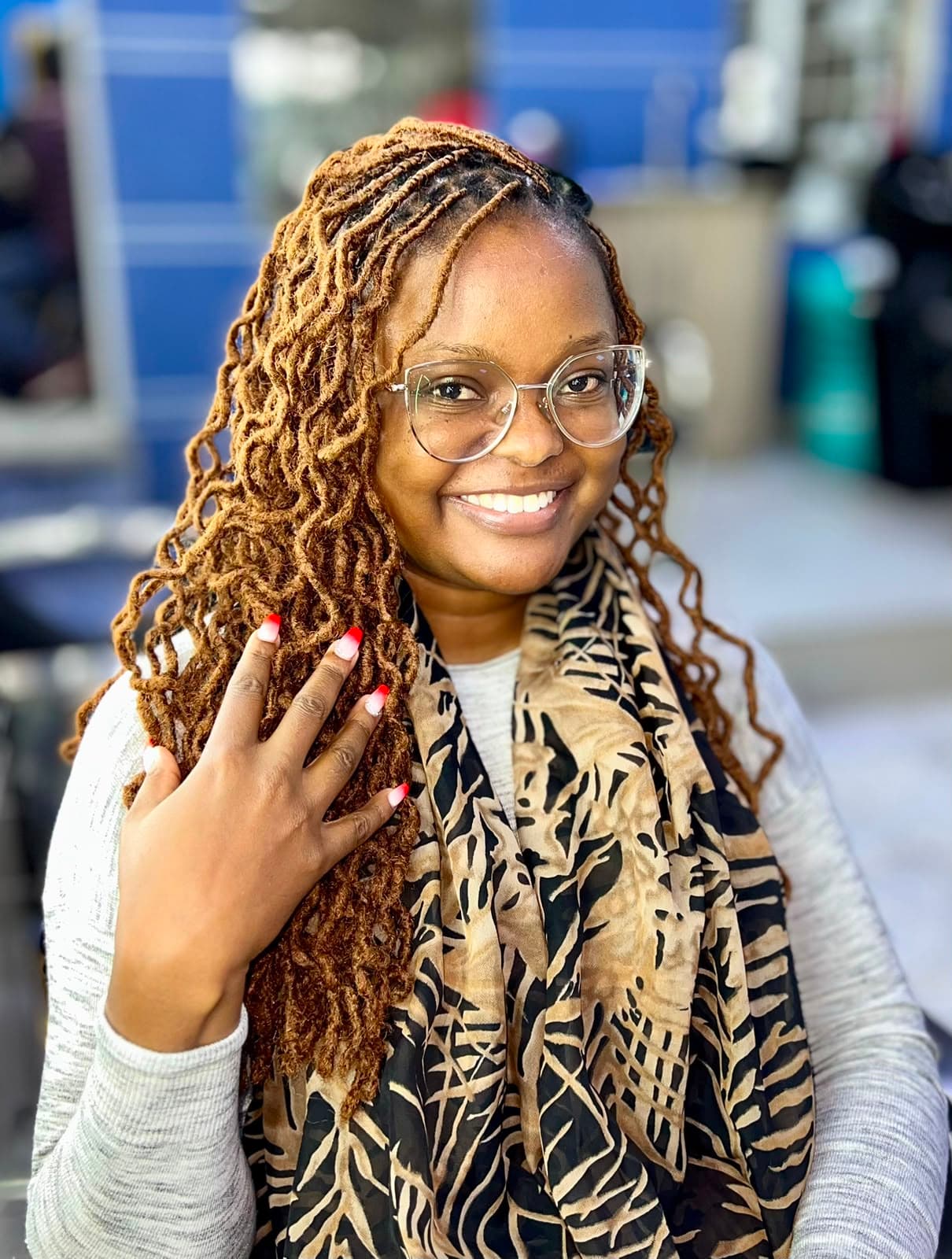 Smiling KYM360 client showing long honey-coloured locs
