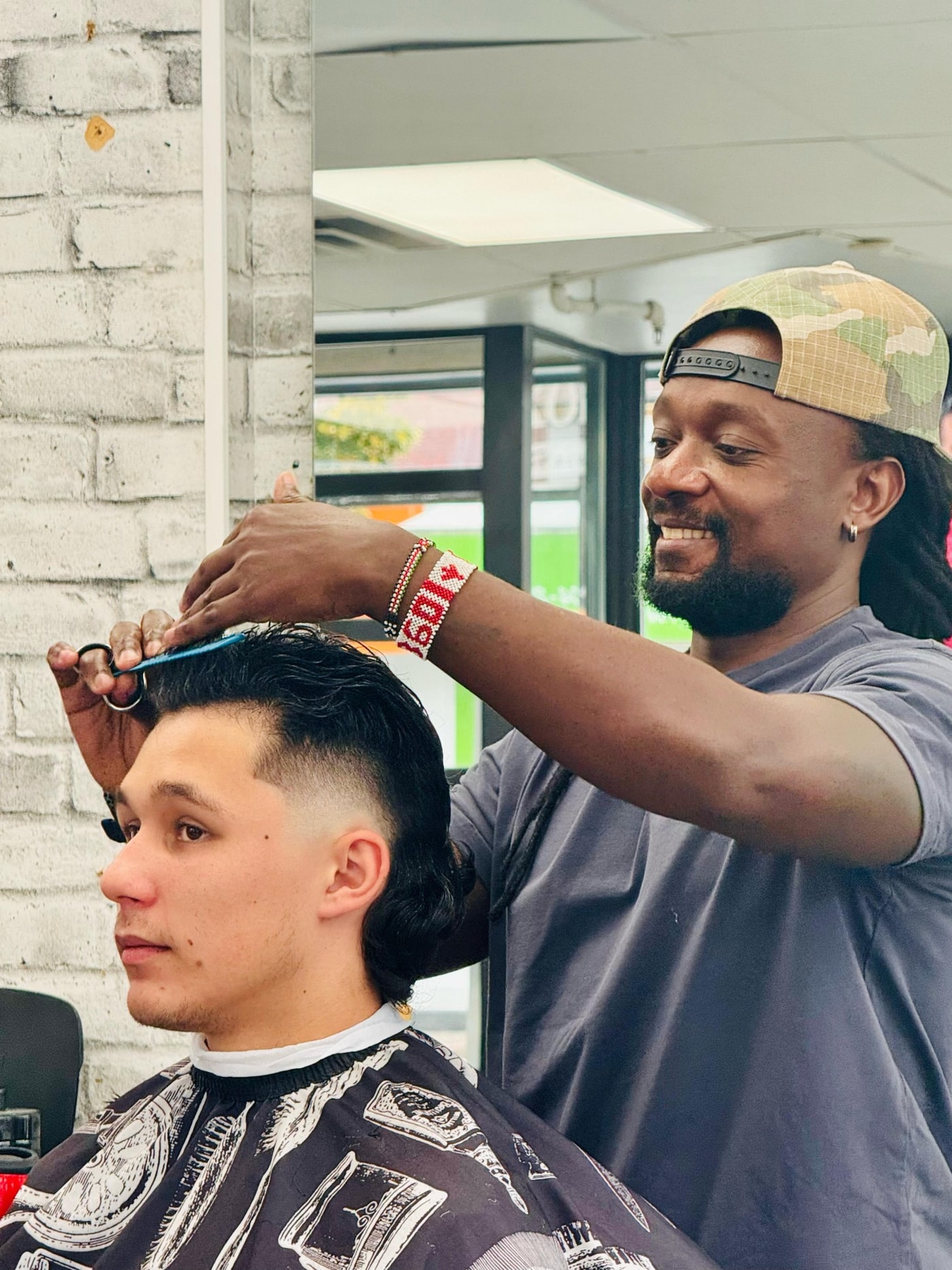 KYM360 stylist shaping a client’s haircut in the studio
